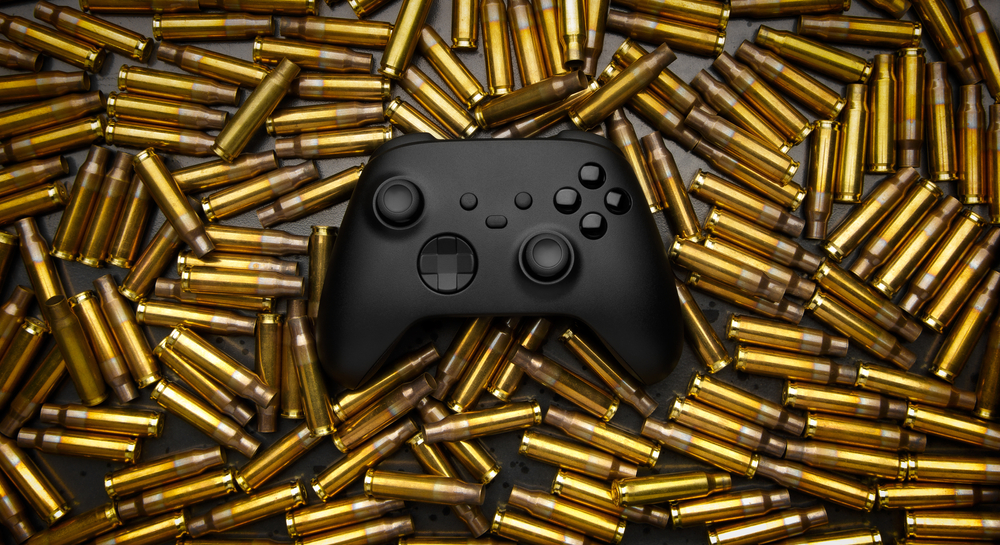 A video game controller surrounded by ammunition.